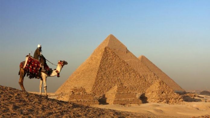 bedouin-and-pyramids-picture-id96319018
