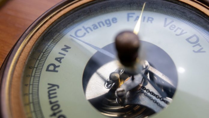 Close up view of an antique barometer dial