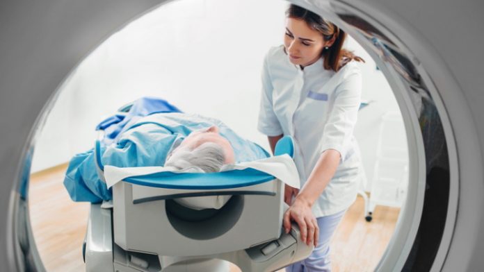 friendly doctor talking to patient . CT Scan in hospital