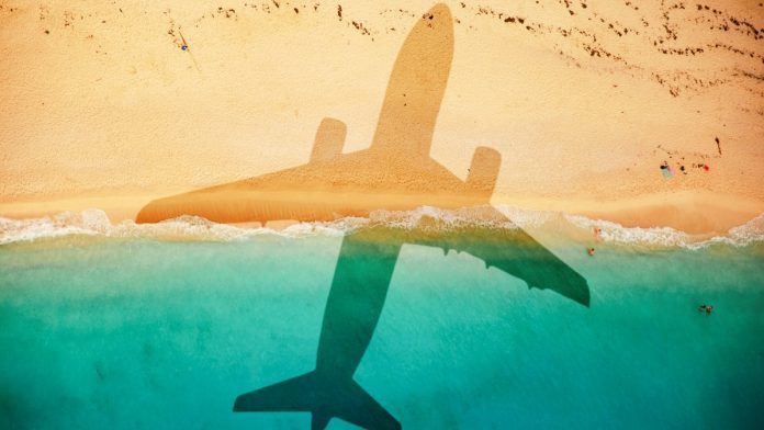 Airplane_shadow_over_beach_iStock-1129846176 An airplane's shadow casted over a beach