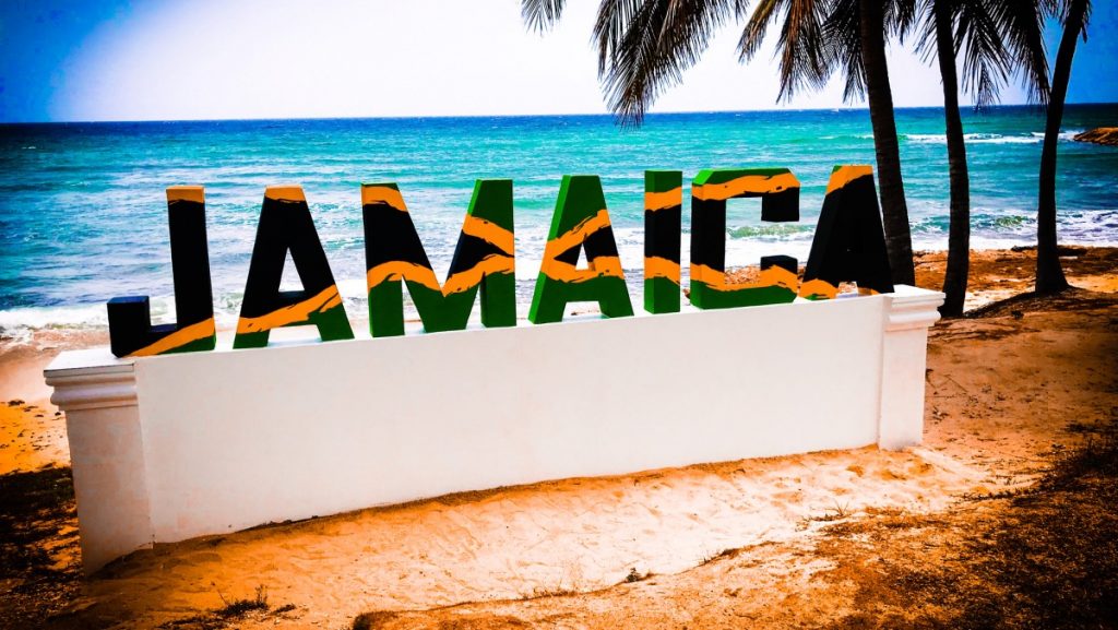 Decorative sign saying 'Jamaica' on a beach