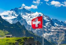 Switzerland targets UAE medical travellers Swiss flag in front on mountains