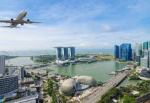 Singapore aims to reopen in September Airplane flying over Singapore