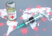 Medical travel needs global vaccine recognition A conceptual image of the COVID-19 vaccine sitting on a map of the world.