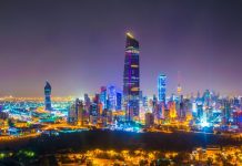 Kuwait restricts outbound travel Night aerial view of Kuwait city