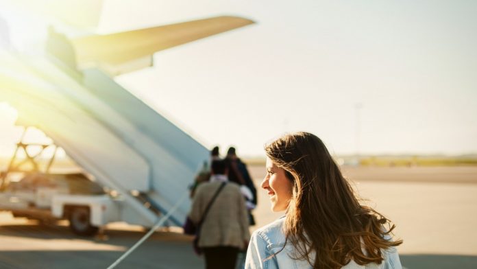 Woman_getting_on_plane_iStock-923799162
