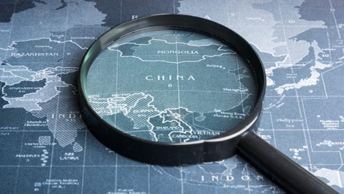 Magnifying glass over China on map