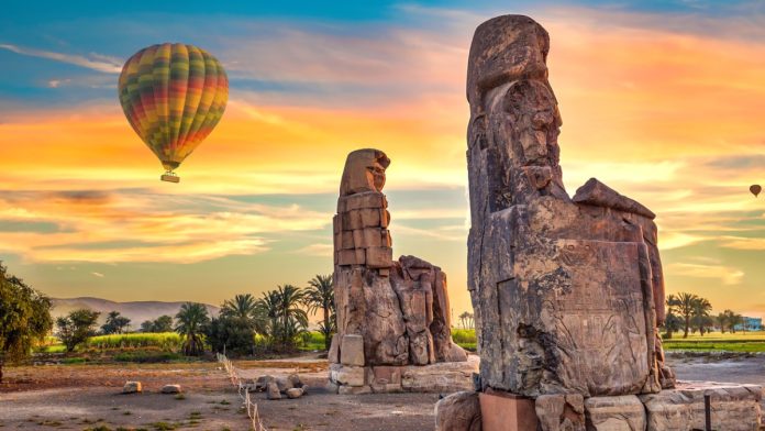 Hot air balloons and Colossus of Memnon in Luxor, Egypt