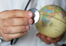 Arabs ‘responsible for 30% of all medical travel’ Doctor holding stethoscope next to a globe