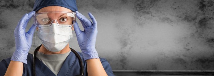 Female Doctor or Nurse Wearing Scrubs and Protective Mask and Goggles Banner