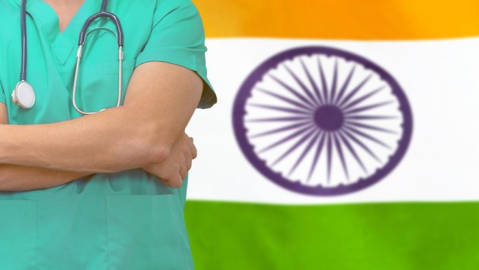 India flag and doctor_iStock-1209934351 Doctor in front of Indian flag