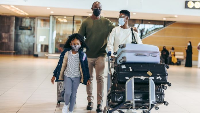 Family at airport_iStock-1333400835