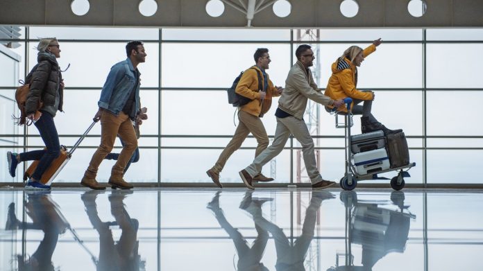 Group travelling through airport_iStock-917043680