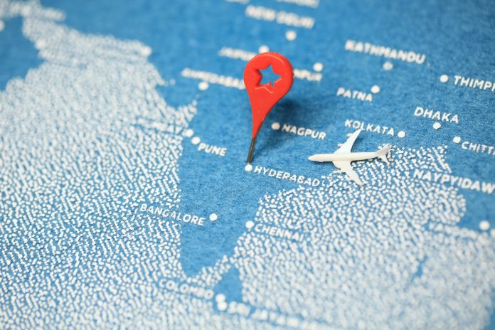 airplane fly on the blue painted map