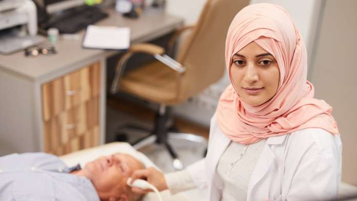 Stock image of UAE nurse treating patient