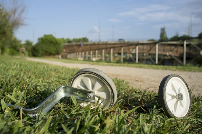 Additional wheels lying on the grass in the park
