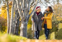 Winners or losers? Woman with grandmother walking in park in autumn