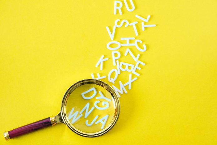 Letters English alphabet fallout magnifying glass, concept of knowledge and learning, on yellow background.