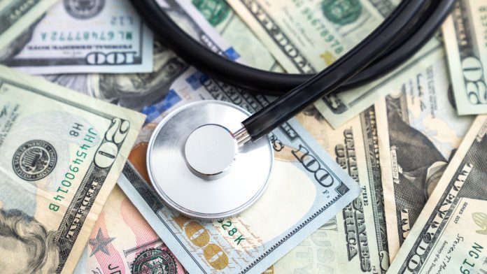stethoscope on american money_iStock-1225227276