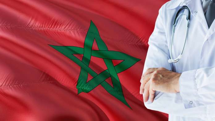 Hospital doctor in front of Morocco flag
