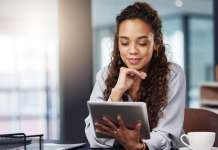 Geography of wellness Woman on a tablet, referencing the Geography of Wellness
