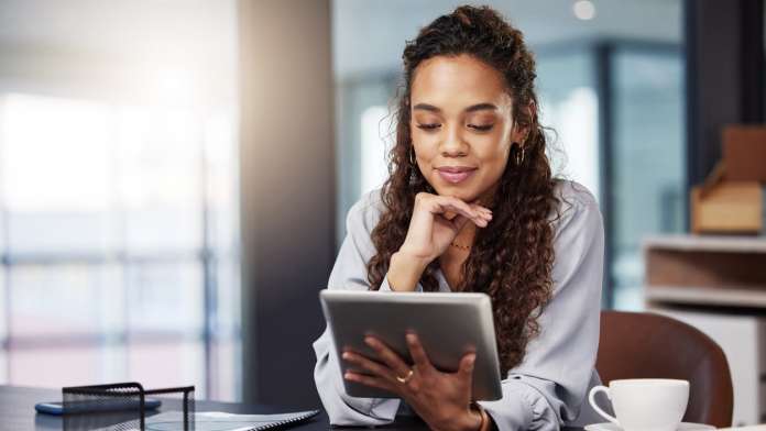 Woman on a tablet, referencing the Geography of Wellness