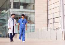 UK health system problems Medical staff in front of hospital