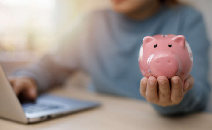 Budget and Saving money concept for financial accounting,Woman hand putting coin in piggy bank, financial plan and Money saving ideas, business finance and investment, life and family planning.