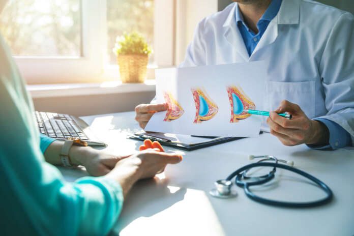 doctor consulting female patient about planned breast plastic surgery