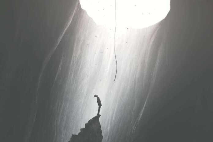 man finding a way to get out of darkness, help from the sky, surreal concept
