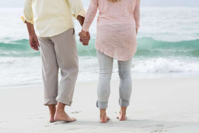 Happy couple walking by the sea