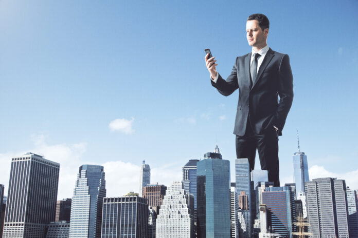 Huge businessman using cellphone