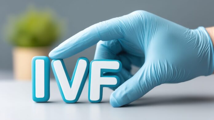 The word IVF and the hand of a specialist doctor. In Vitro Fertilization concept. Medical technology that assists with pregnancy. The growth of the specialized medical business.