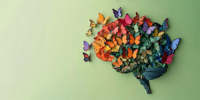 Human brain made of multi-colored tangled threads on blue background